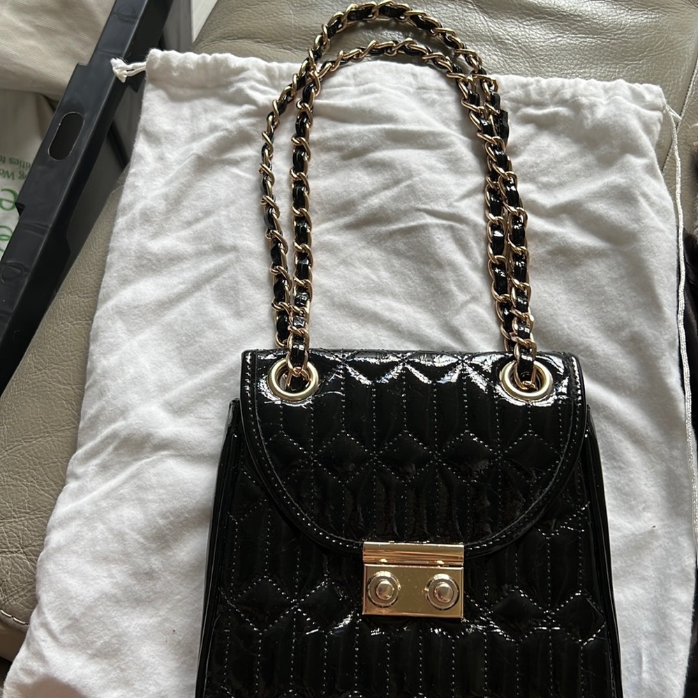 Black patent leather clutch with gold and black chain strap excellent condition.